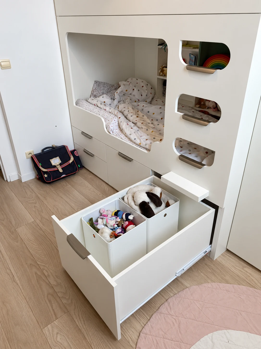 Grand tiroir ouvert sous le lit capsule, avec deux bacs pour les jouets